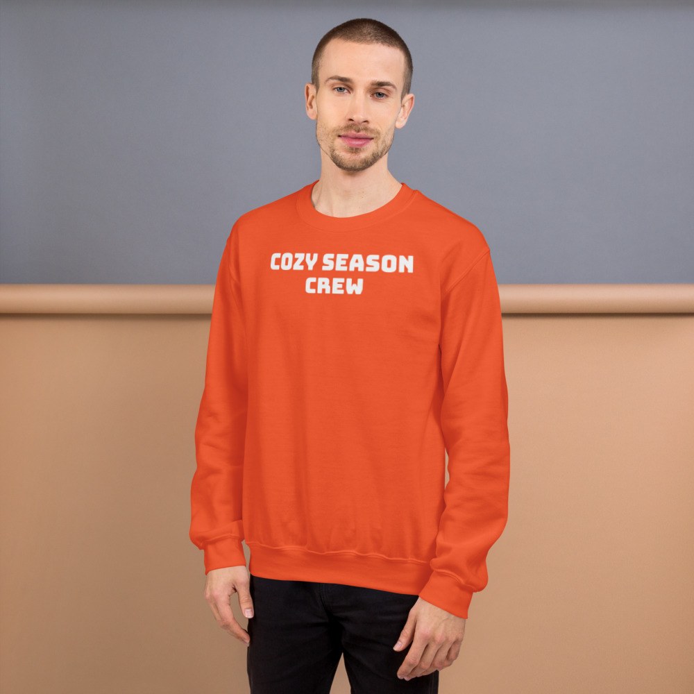 Orange jumper reading 'Cozy season crew'